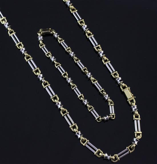 An 18ct two-colour gold baton and reel link chain necklace and bracelet en suite, bracelet 8in.